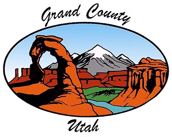 Arches, canyons, red rock formations, and a distant mountain peak