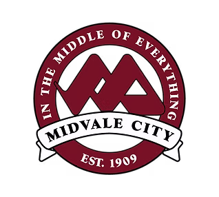 Red circular logo with interlocking 'M's and "MIDVALE CITY EST. 1909."