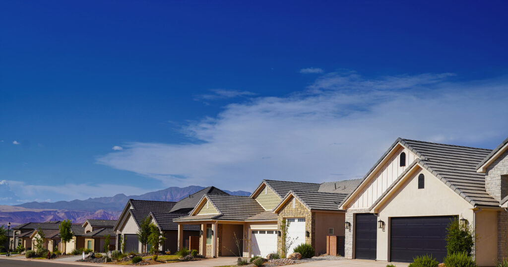 Row of modern single-story homes under a wide blue sky